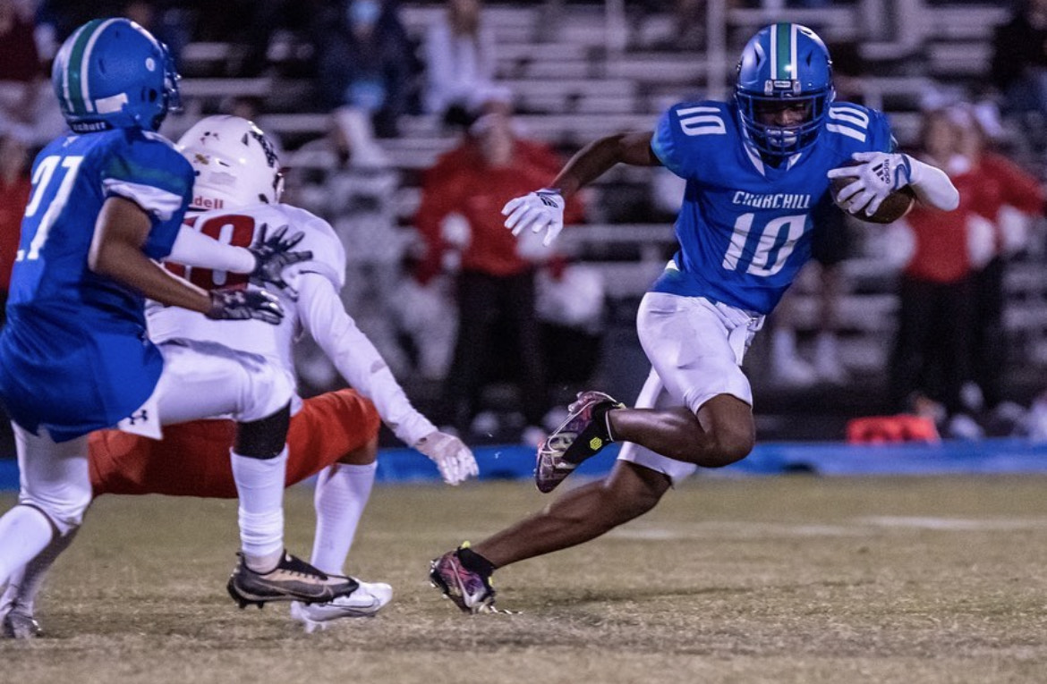 WCHS senior Layton Johnson is captured running from opponents with the ball. He has committed to continue his football career in college and is one out of many WCHS athletes who are currently in the transition phase between high school and college athletics. 