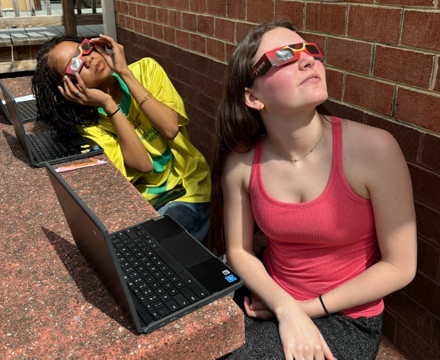 Juniors Alex Demitz and Morgan Branch use their glasses to watch the solar eclipse on April 8, 2024.