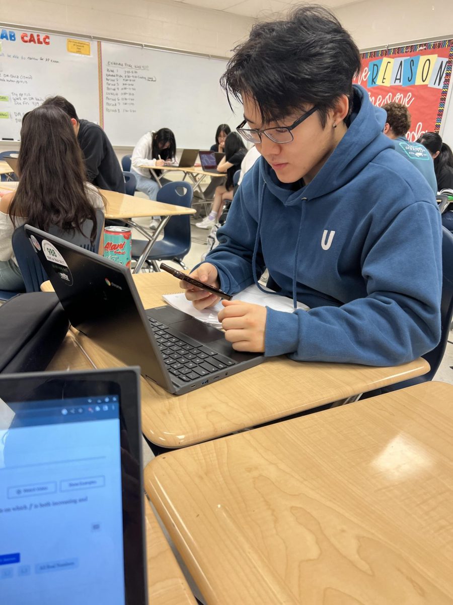 WCHS junior Jeremy Kwon checks his phone during SMOB voting. Voter apathy has caused many students to stop caring about the SMOB or not vote at all.