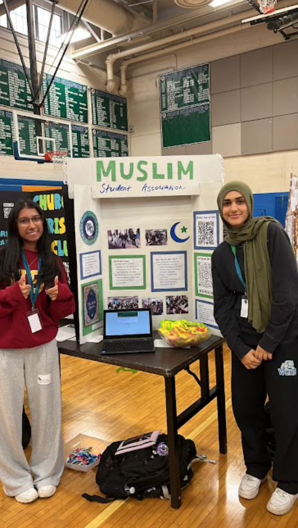 WCHS seniors and officers of the Muslim Student Association (MSA) Aleeza Ali and Noura Taheri pose in front of their poster board. MSA had a very successful Club Day and were able to recruit many new members for the 2024-25 school year.	