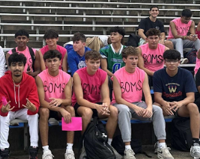 WCHS senior boys are sitting on the bleachers, waiting to perform their Boms performance for the pep rally.