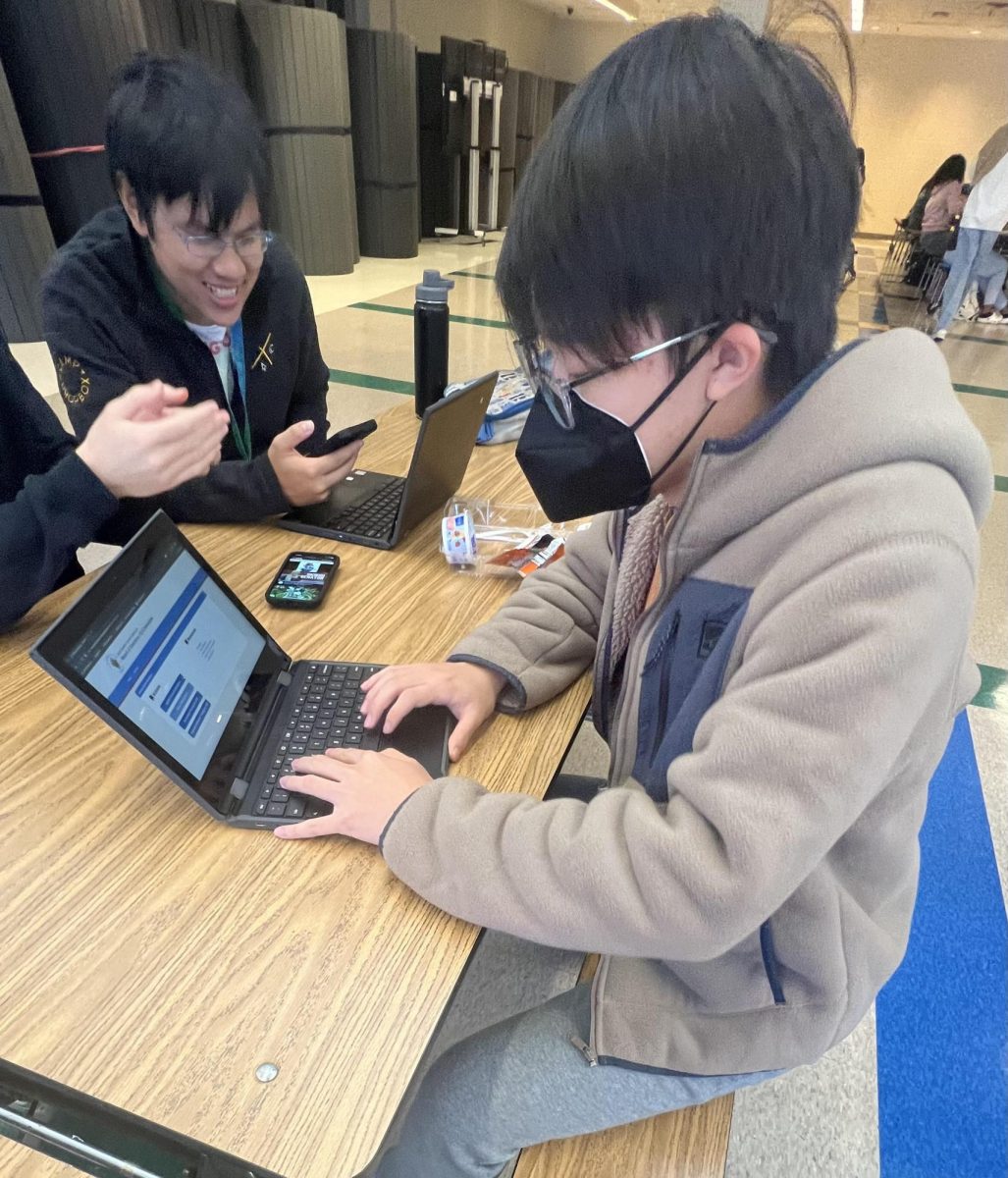 WCHS senior Steven Li checks "EJ Connect" for his election worker status. As part of civic engagement opportunities, MCPS has digitized most of their systems to ensure easy registration to programs. 