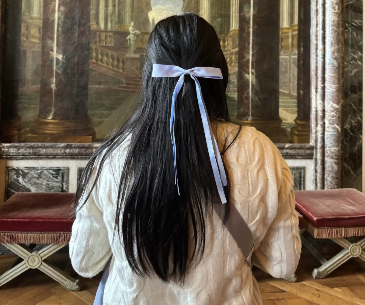 WCHS senior Thao Nguyen wears a bow in her hair while exploring the Palace of Versailles. 2023 was all about bows, but this trend is coming to an end as bows become oversaturated on social media. 