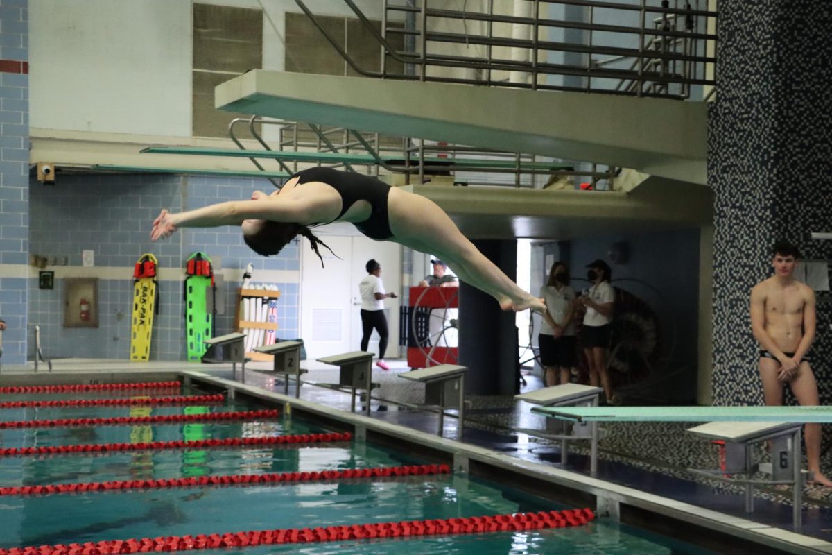 WCHS senior and dive team captain, Annika Shauf demonstrates a back dive at a dive team practice. Shauf spent her first to high school years on the swim team and transitioned to dive during her junior year.