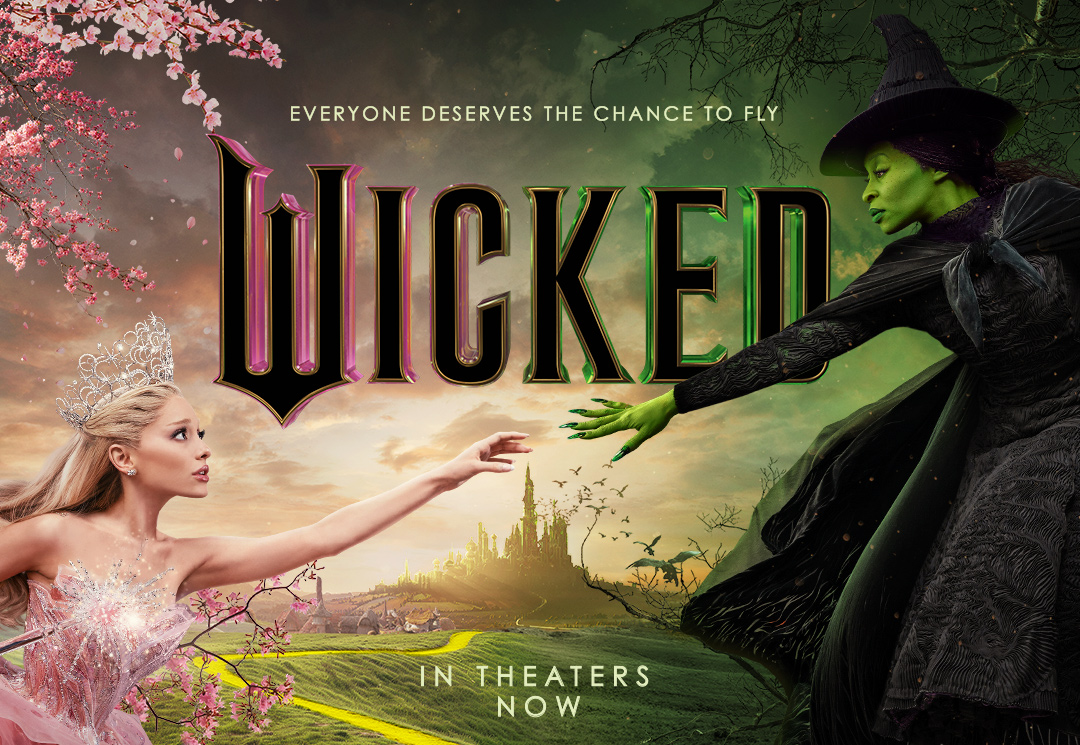 The official "Wicked" movie poster shows Glinda, played by Ariana Grande, reaching towards Elphaba, played by Cynthia Erivo.