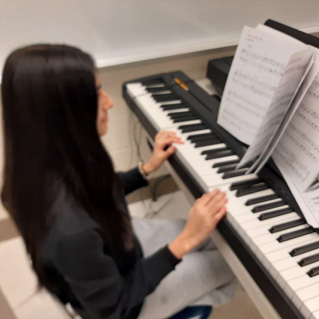 Diya Blatt practicing her piece on the piano. In piano 1, students are given a book to practice off of, that consist of pieces on their level.