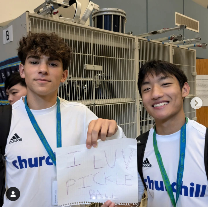 WCHS students, Augustus Ulrich and William Jiang, show their support for the Pickleball Club during Club Day, on Wednsday, Jan. 14.