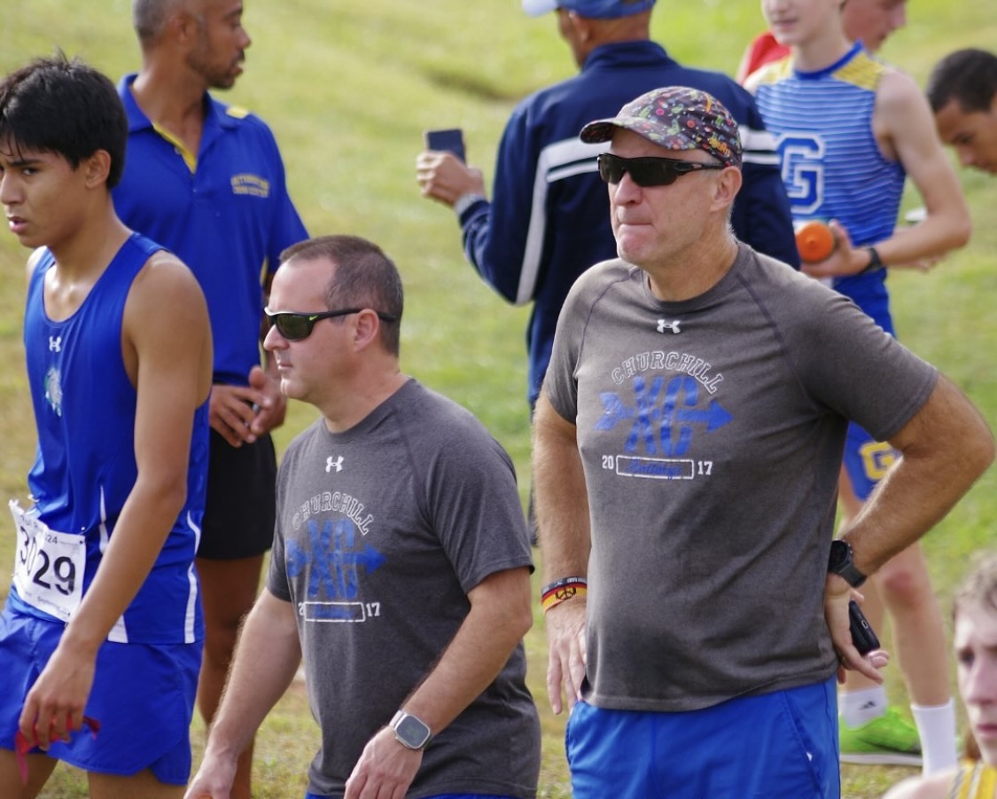 October 6th 2024, Coach Jacobson (right) and Coach Scott (left) look on at the runners preparing for the meet. 