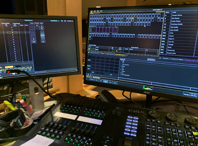 Elizabeth Seldin is using the light board to control the color, hue, brightness, and patterns of the stage lights and turning them on and off by entering their respective code during the performance. 