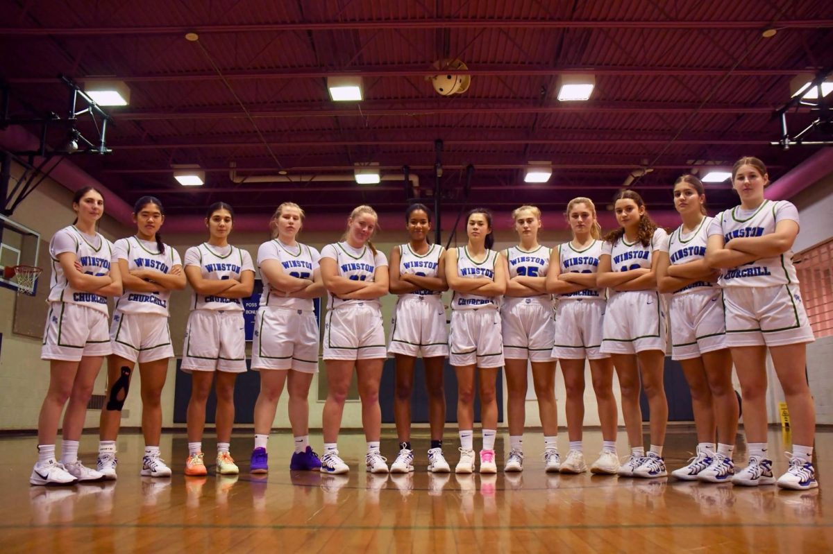 WCHS freshman Ashley King stands by her Varsity team as the youngest basketball player and starter on the team.